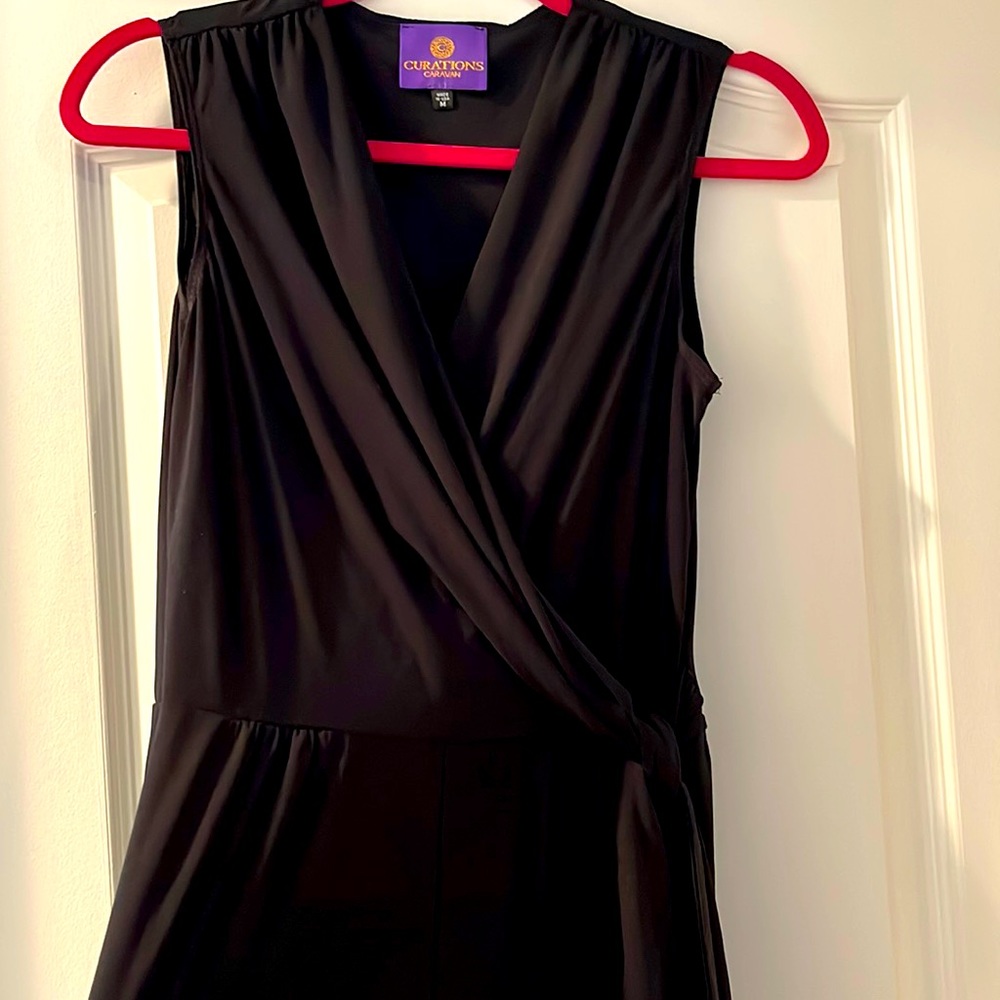Black stretchy one pierce pantsuit with cross cross top and tie. Never worn